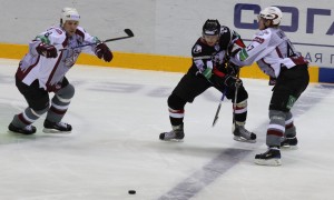 Martins Cipulis (47) stops his opposite in his tracks as Sandis Ozolins (8) attempts to reach the loose puck. Photo used courtesy of Dinamo Riga.