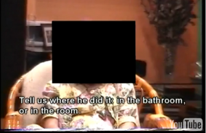 This screenshot is from one of the videos on www.pedofiliai.com. In it Kedys interviews his daughter, seen here with her face blacked out, and asks her to describe the alleged rape and molestation she underwent in explicit detail. The interview was conducted in Lithuanian but Kedys insterted English subtitles.