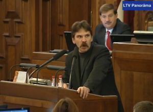 Saeima deputy Ingmars Līdaka shouts “Shut your mouth!” ("Aizver muti!") at the parliament in this screenshot of the YouTube video.