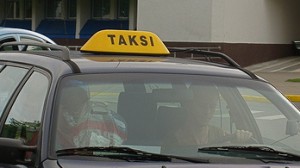 A taxi pulls out from the Vinlius International Airport. The airport has accused the taxi companies of collusion, but the taxi companies say the airport's charges for standing spots is forcing them to charge more.