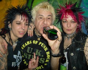 Charlie Harper, lead singer of the UK Subs, enjoys a beer with a couple fans after performing. Monday's show marked the group's first appearance, along with The Vibrators, in Lithuania.