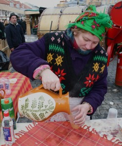 A woman pours hot beer at 2009's Kuzuiko Mugė in Vilnius. Photo by Nathan Greenhalgh.
