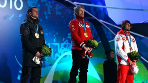Martins Dukurs of Latvia receives the silver medal, Jon Montgomery of Canada receives the gold medal and Alexander Tretyakov of Russia receives the bronze medal during the medal ceremony for the men's skeleton at the Vancouver 2010 Olympics. Photo by Richard Heathcote/Getty Images