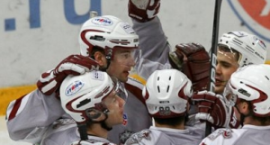 Dinamo Riga players huddle to discuss strategy before gametime starts again. Their tenacity paid off against Avangard, beating them 5-3.