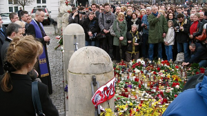 A crowd in Warsaw mourns the tragedy Saturday afternoon.